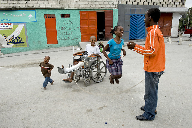 Children jump rope and laugh, with boy who was injured in quake. Photo courtesy of Hope for Haiti Foundation.