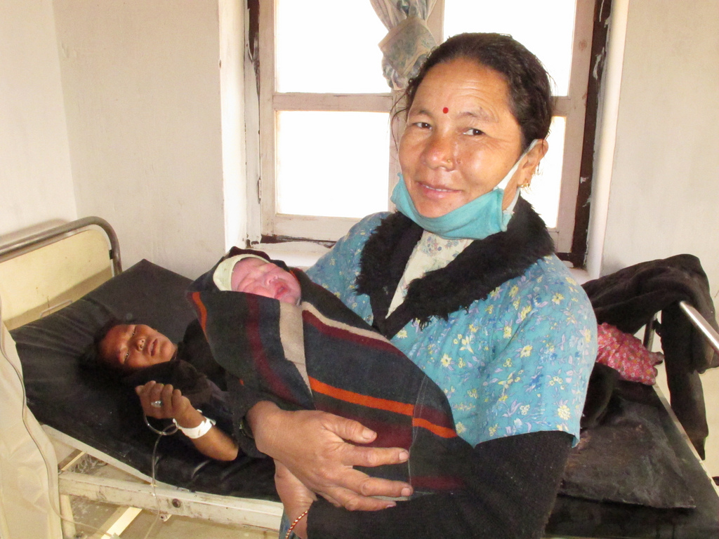 A skilled birth attendant with One Heart World-Wide Nepal smiles after a safe delivery.