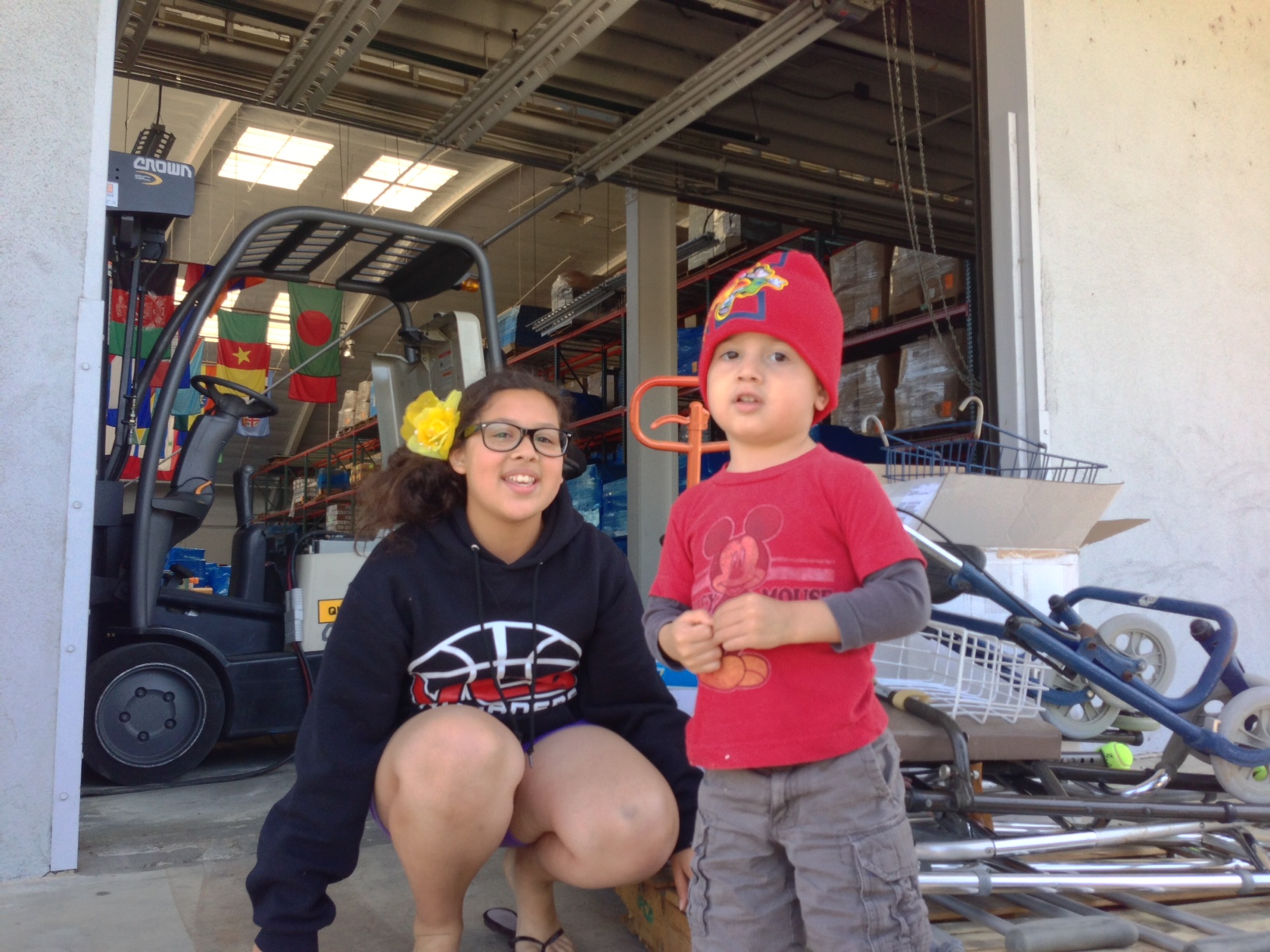 Iselle and her baby brother who inspired her project pose outside Direct Relief's warehouse while delivering orthopedic supplies she collected. Iselle and her baby brother who inspired her project pose outside Direct Relief's warehouse while delivering orthopedic supplies she collected.