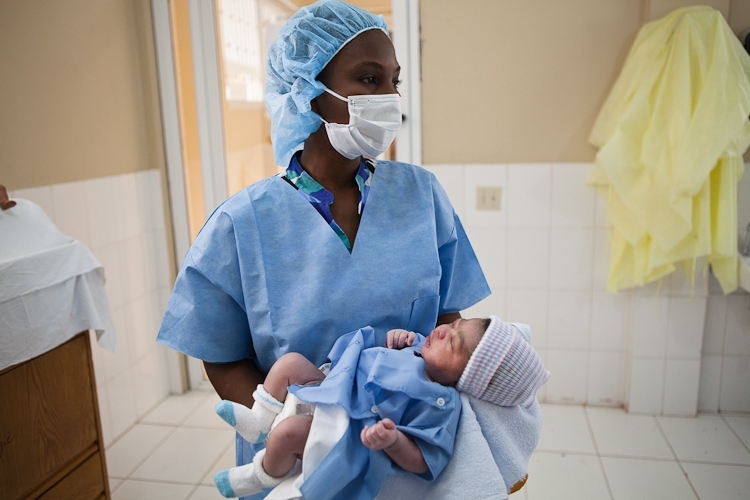A nurse holds a new baby born at Haiti Hospital Appeal's maternity ward. Courtesy photo. A nurse holds a new baby born at Haiti Hospital Appeal's maternity ward. Courtesy photo.