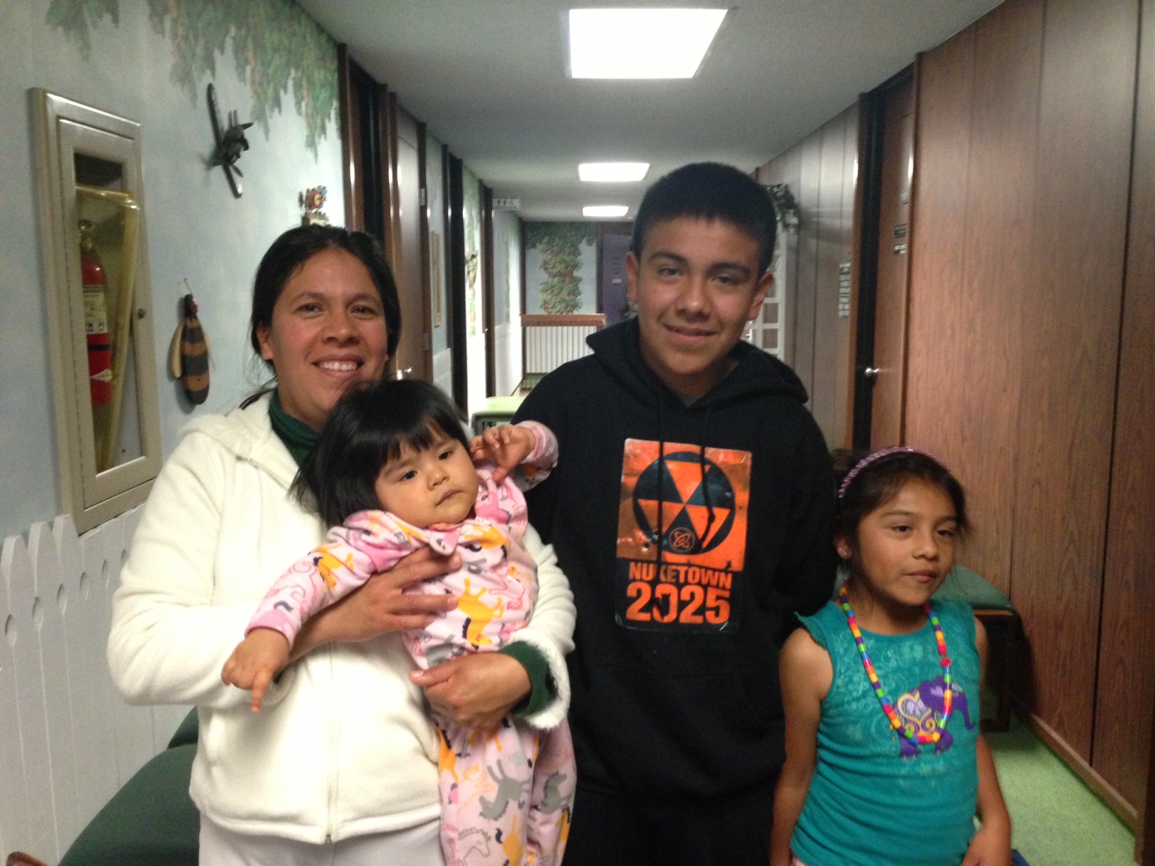 From left, Maria de la Cruz, holds her one-year-old daughter, while Alfredo and his seven-year-old sister stand by at the Healthy Smiles dental clinic. From left, Maria de la Cruz, holds her one-year-old daughter, while Alfredo and his seven-year-old sister stand by at the Healthy Smiles dental clinic.