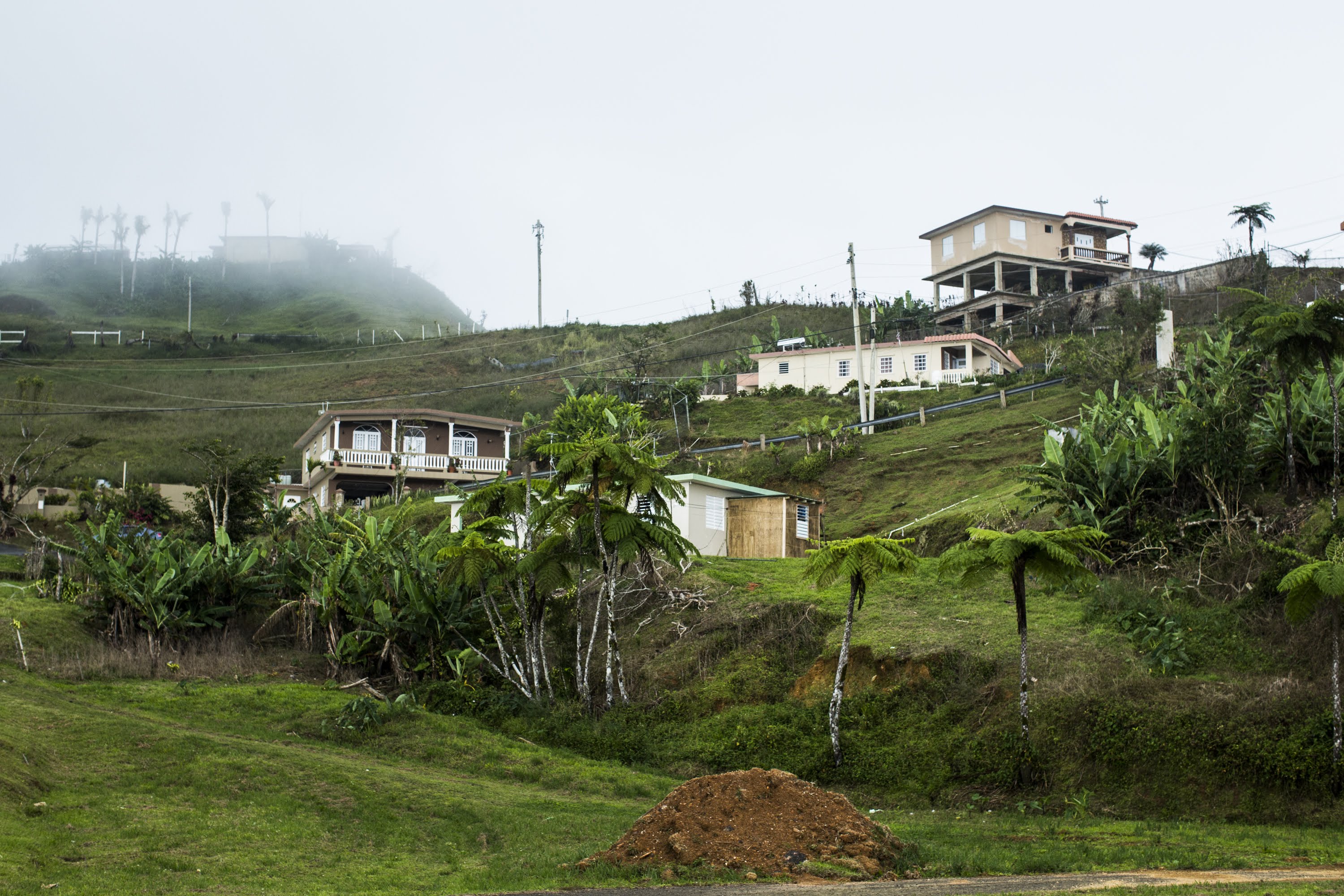View of Bauta Abajo community in Orocovis, P.R., on April 5, 2018. The mountain top community has been without power since hurricane Irma hit the island 7 months ago, leaving the 300 families without a reliable water source. Por Los Nuestros, a local non-profit that was created in response to hurricane Maria’s aftermath, has been working in the community to donate the installation and equipment to energize and store solar power for their potable water system. Months after the storm the water pumps were being powered by a gas power generator, that could only provide intermittent water of the residents. With funds from Direct Relief two solar power systems could be completed for their two water pumps. (Erika P. Rodríguez for Direct Relief)