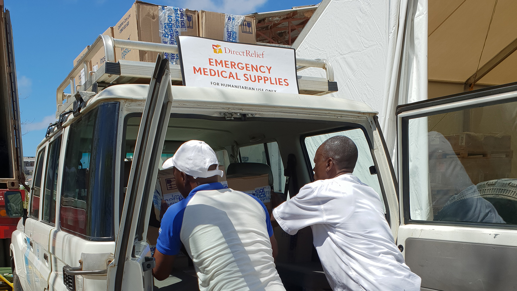 Medical staff from Health Alliance International unload medical supplies from Direct Relief at temporary clinics in Mozambique in April, 2019. Direct Relief has been supporting the work of local groups in Mozambique as they work to treat patients still impacted by the two cyclones that swept through the country earlier this year. (Photo courtesy of Health Alliance International)