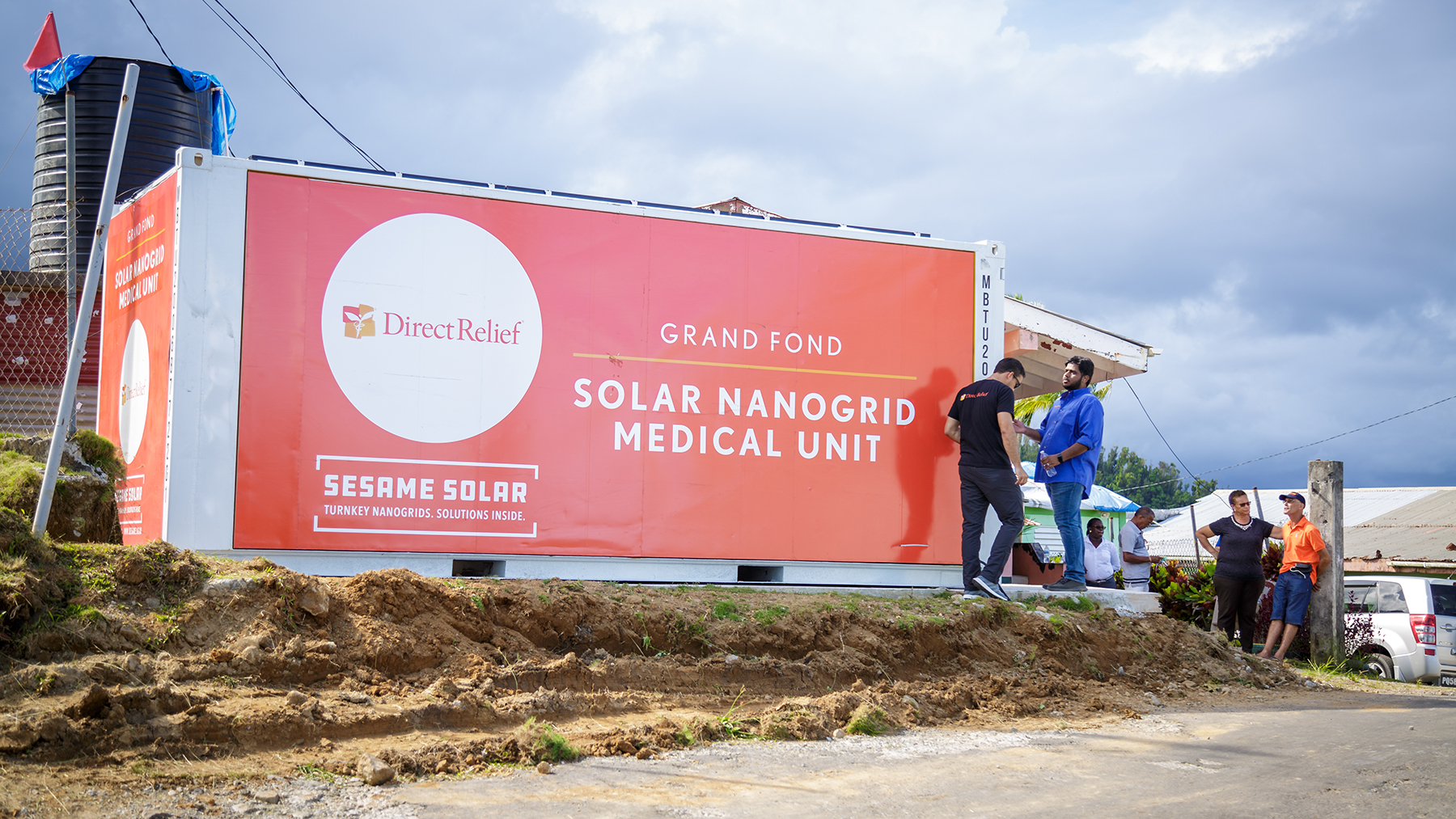A solar nanogrid is unveiled in Grand Fond, Dominica, on Oct. 4, 2019. The nanogrid provides emergency power, water purification and refrigerated storage for medicines like vaccines. (Photo by Chad Ambo for Direct Relief)