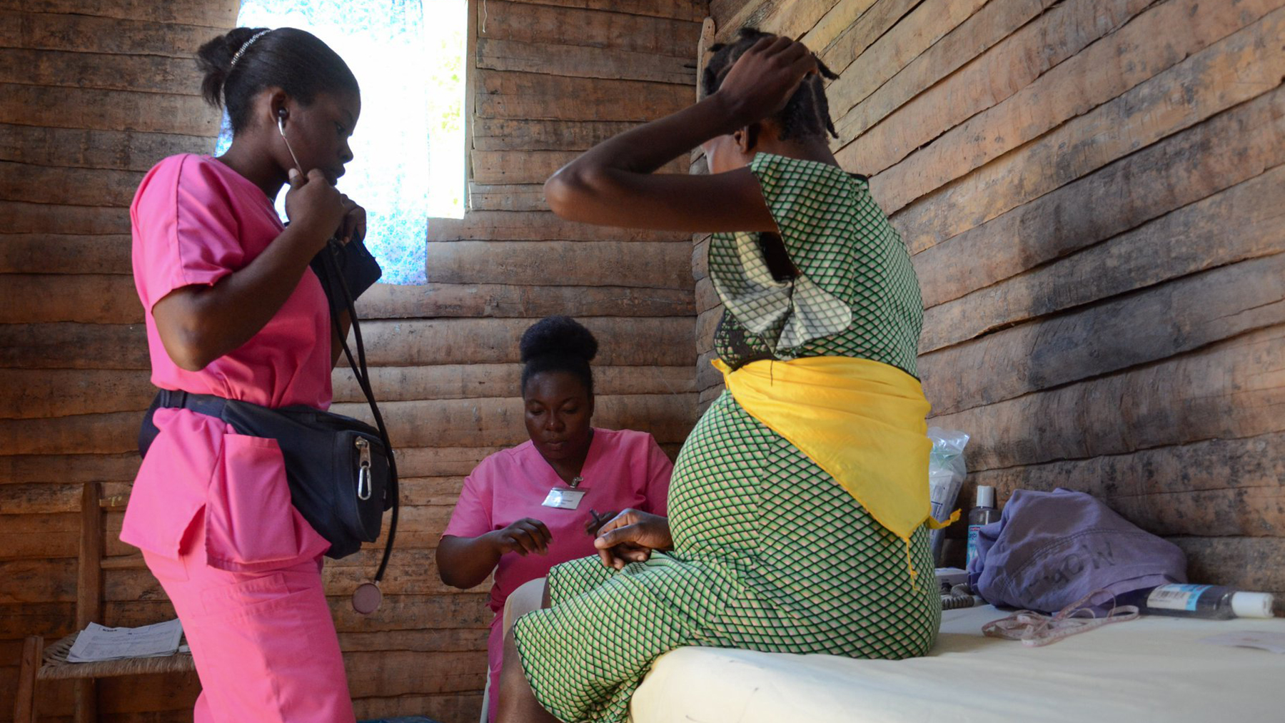 Midwives from the group, Midwives for Haiti, examine a patient during a prenatal visit. (Photo by Phalonne Pierre Louis/FotoKonbit)
