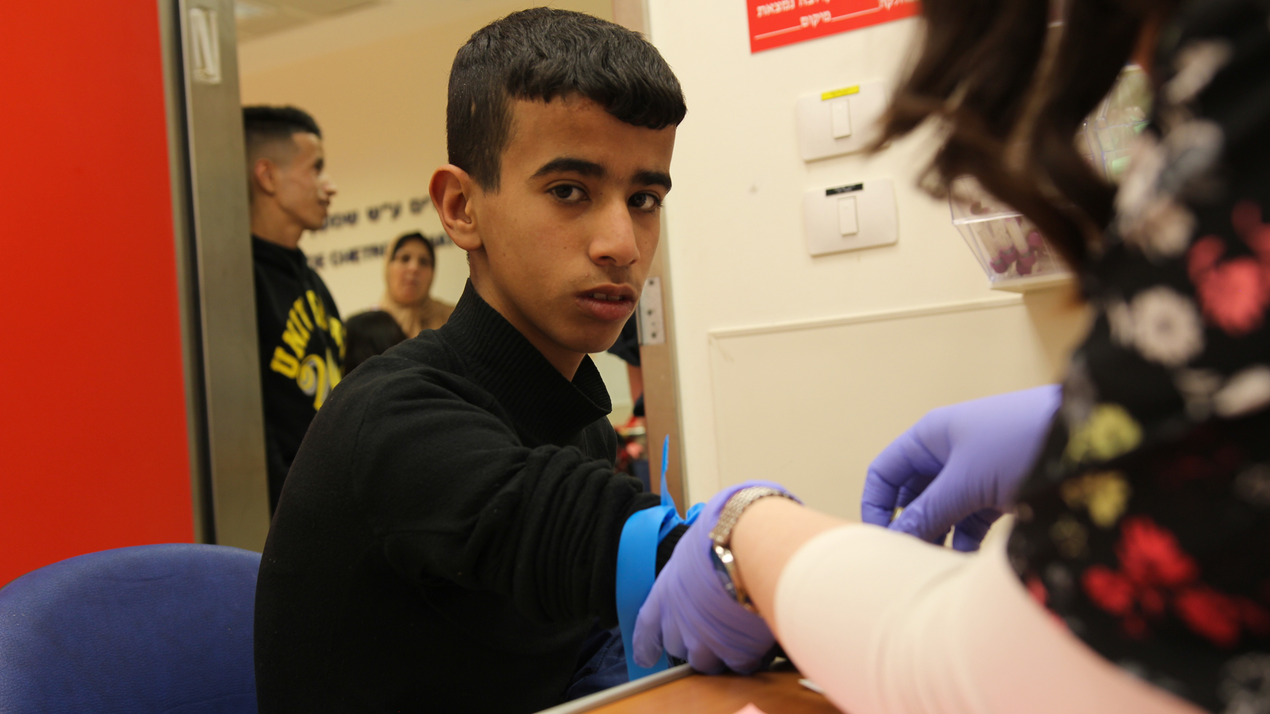 Seventeen-year-old Mahmud prepares for his infusion therapy to manage Gaucher disease at a hospital in Jerusalem. Mahmud and his family travel from Gaza into Jerusalem for his treatments. (Anushka Hauerstock for Direct Relief)