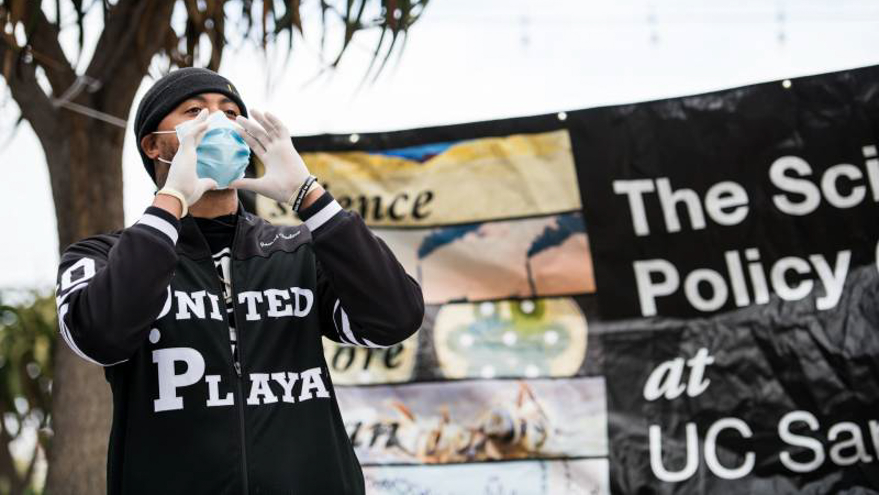 Jamal Trulove calls out to people passing by on Fillmore Street in San Francisco to let them know they are giving away free hand sanitizer and face masks. (Photo Courtesy of Tru Narrativ)