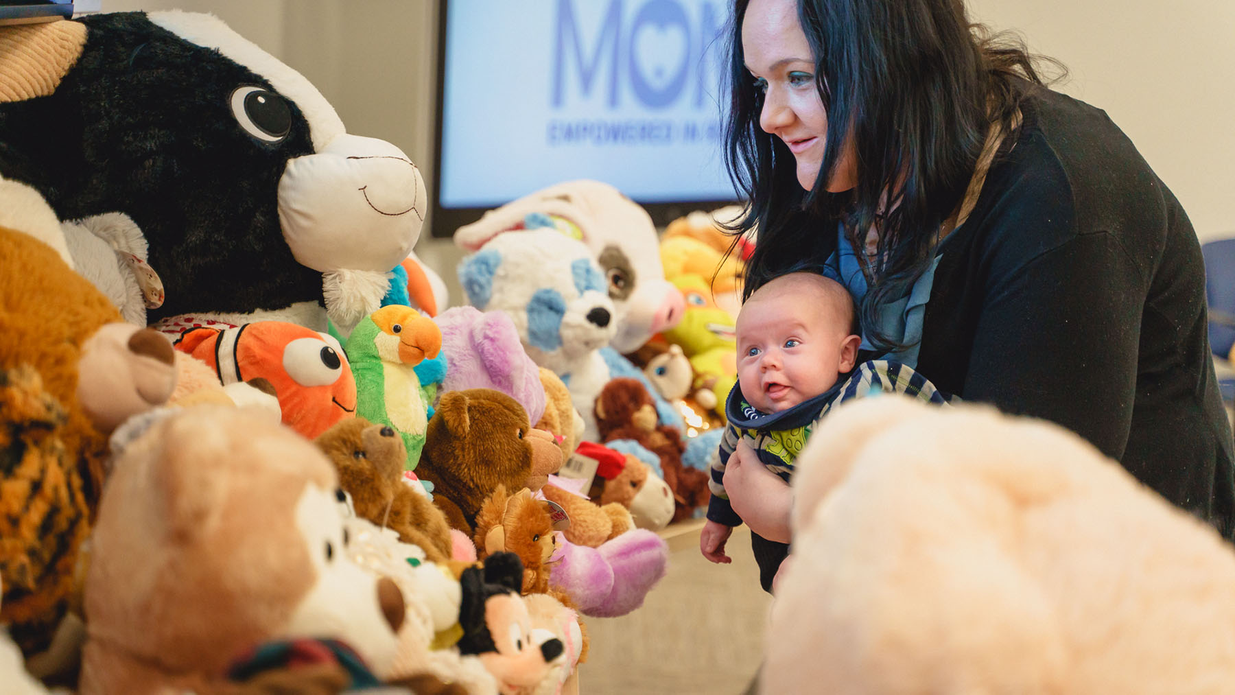 A new mom and her baby attend an event at the Wright Center for Community Health. The health center's Healthy MOMS program supports women addressing opioid dependency during pregnancy. (Photo courtesy of the Wright Center)