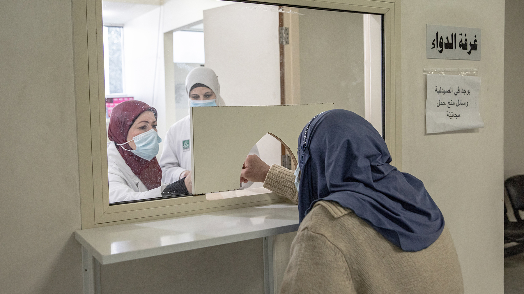 A pharmacist at the Rafik Hariri University Hospital in Beirut, Lebanon, dispenses medication in February 2021. Direct Relief has been able to provide critical donations to the facility since 2020's explosion. (Photo by Francesca Volpi for Direct Relief)
