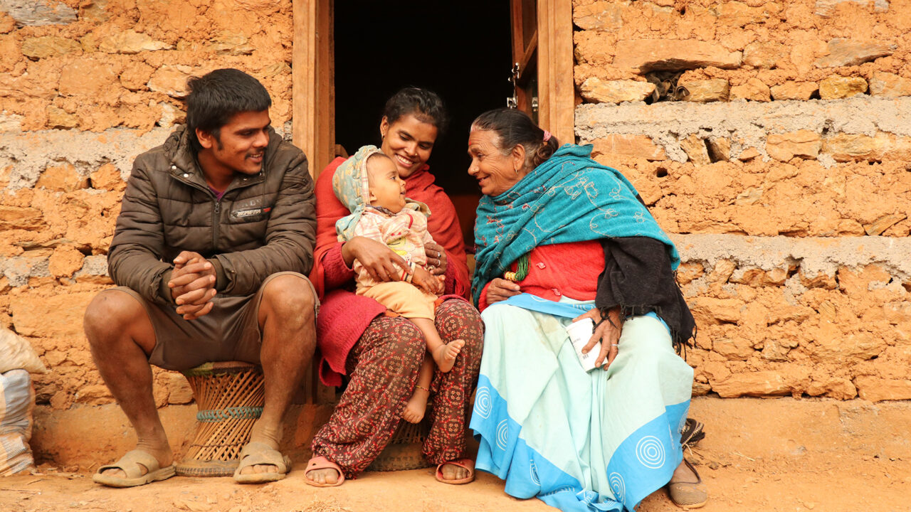 A Nepali family plays with their child. (Photo courtesy of One Heart Worldwide)