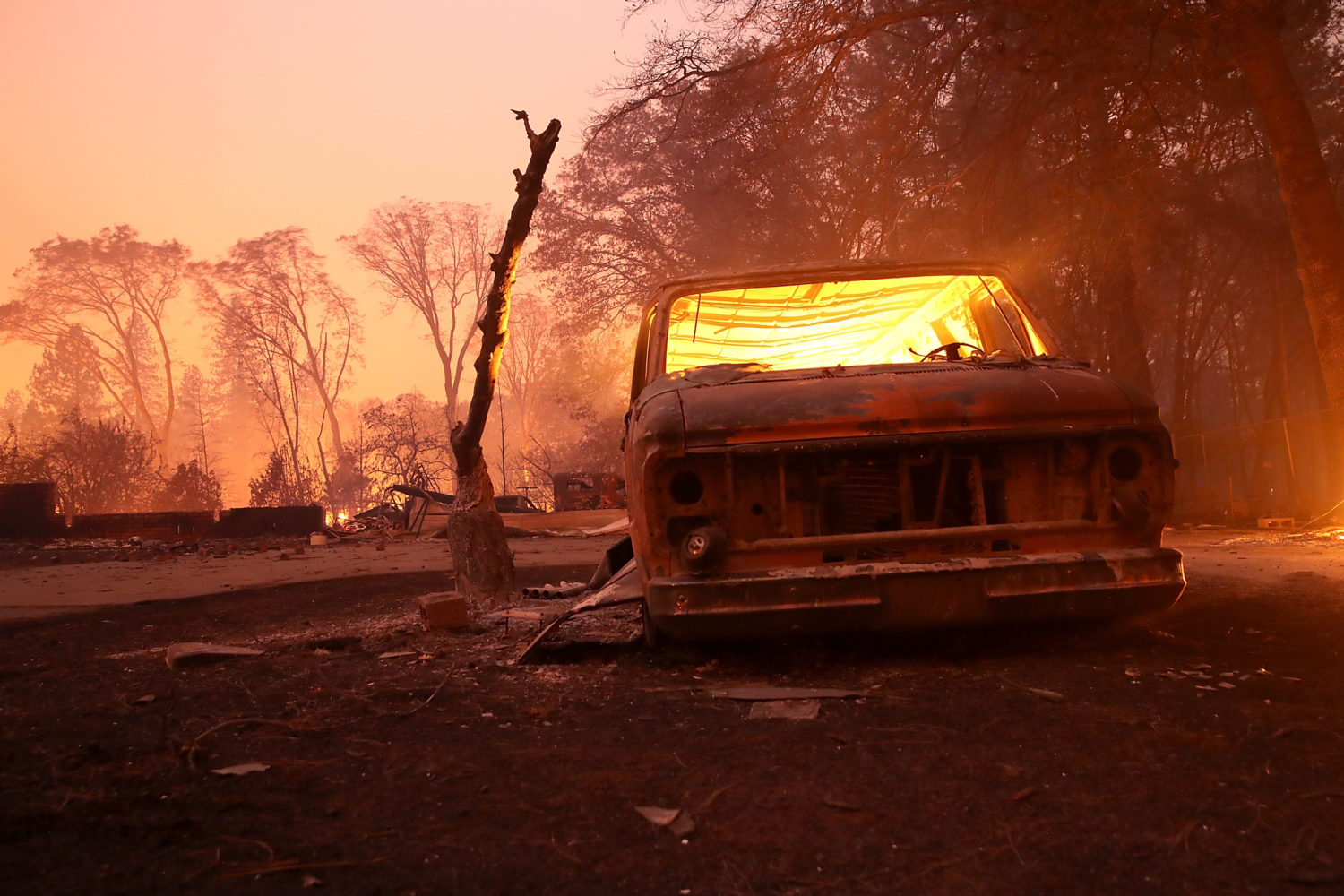 A burned-out van smolders after the Camp Fire moved through Paradise, California on Nov 8, 2018. (Photo by Justin Sullivan/Getty Images)