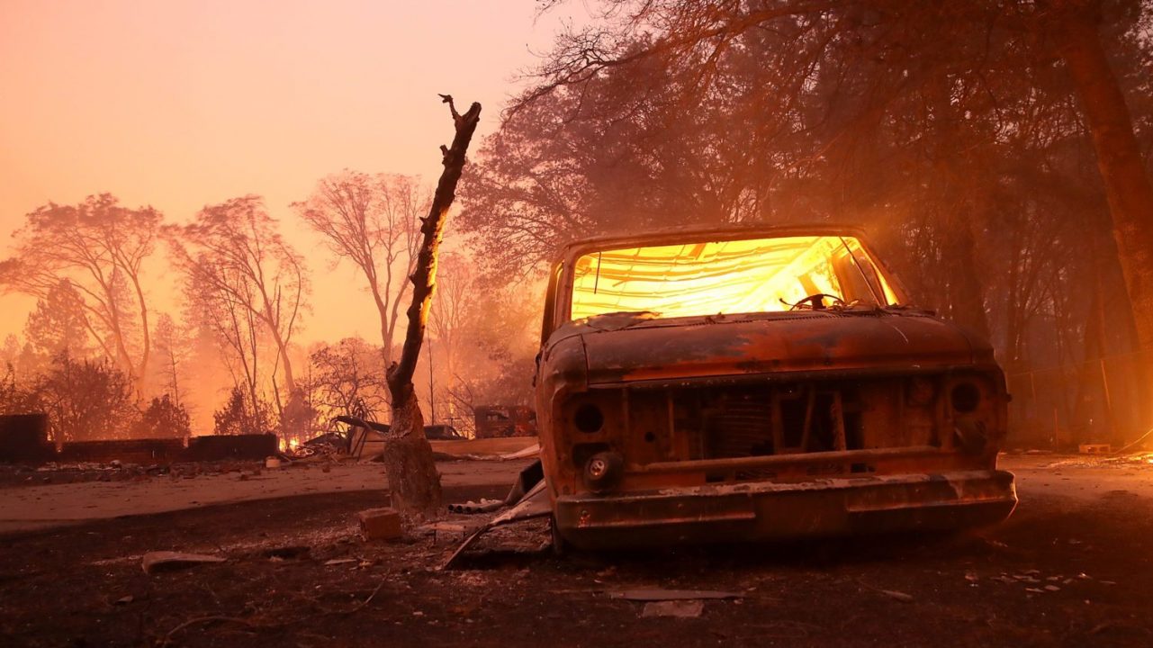 A burned-out van smolders after the Camp Fire moved through Paradise, California on Nov 8, 2018. (Photo by Justin Sullivan/Getty Images)