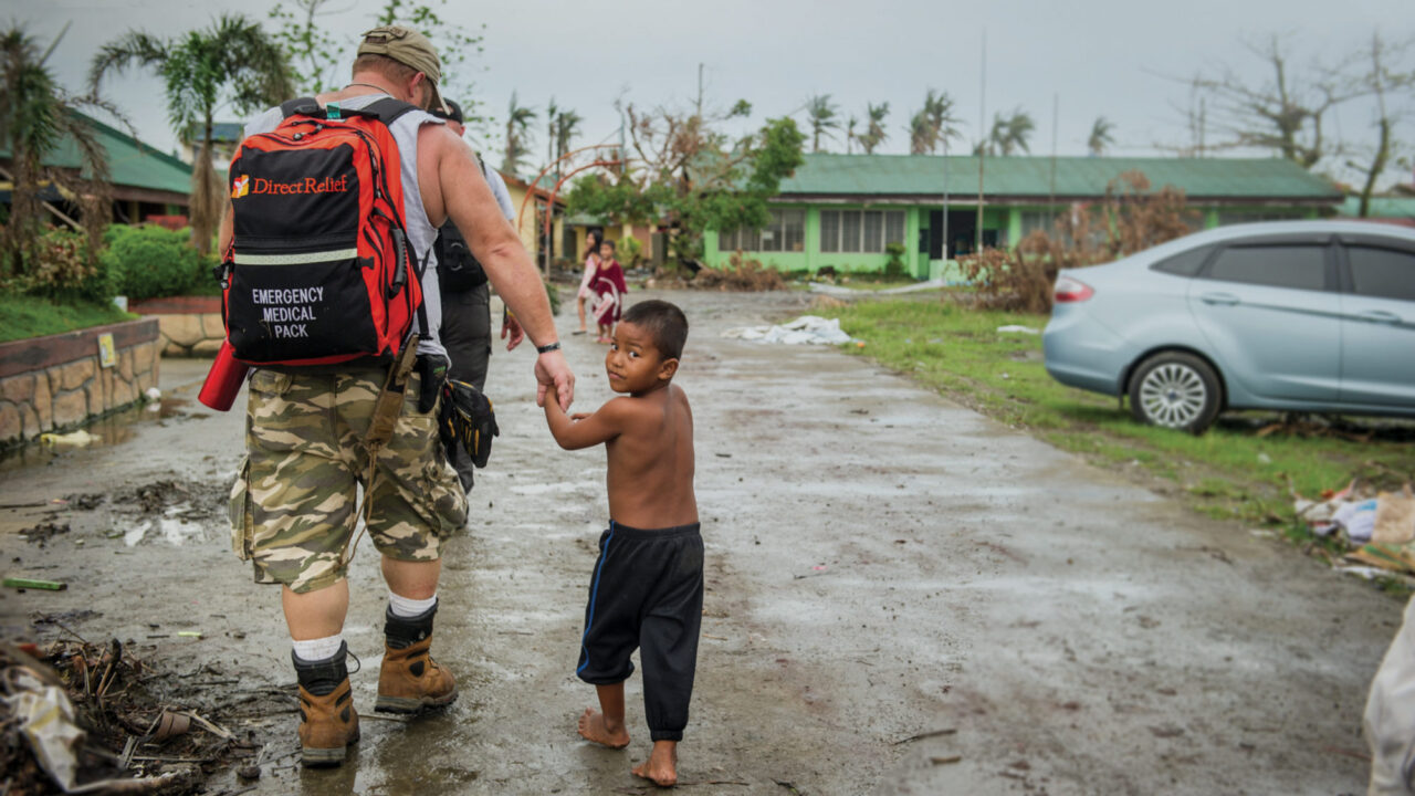 Emergency responder and child after Typhoon Haiyan
